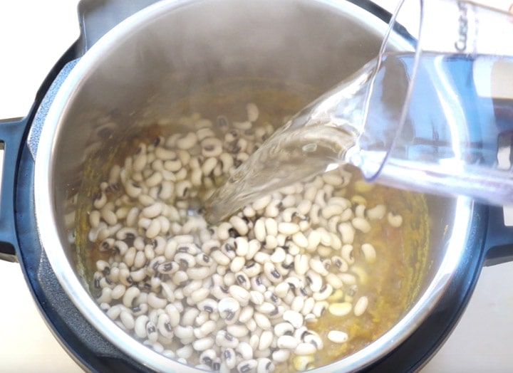 Black eyed peas curry (Lobhia) steps - Piping Pot Curry-3 Water being added to Black eyed peas in a pressure cooker
