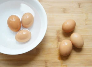 3 Eggs in an ice-bath and 3 on a wooden board