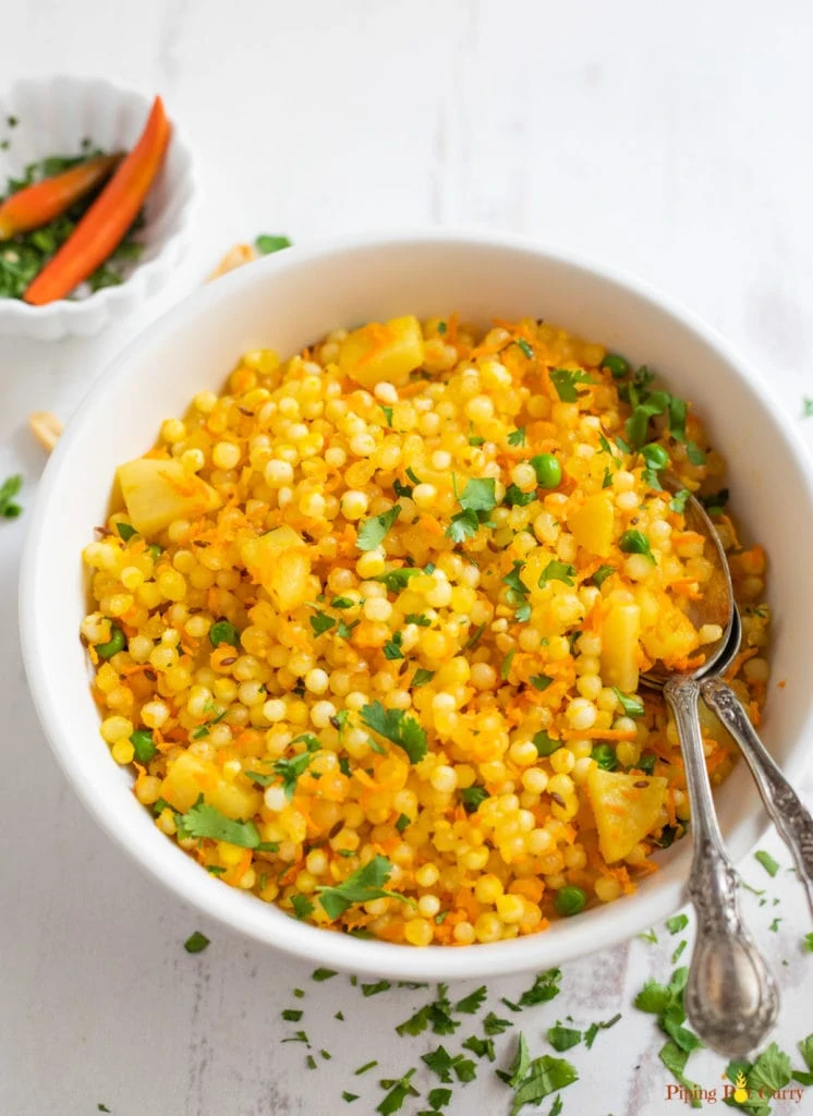 Healthy Sabudana Khichdi with carrots and peas in a white bowl