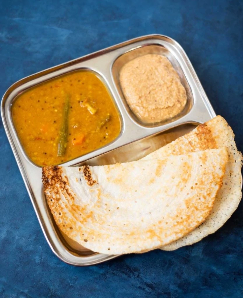 Dosa with sambar and chutney in a steel plate