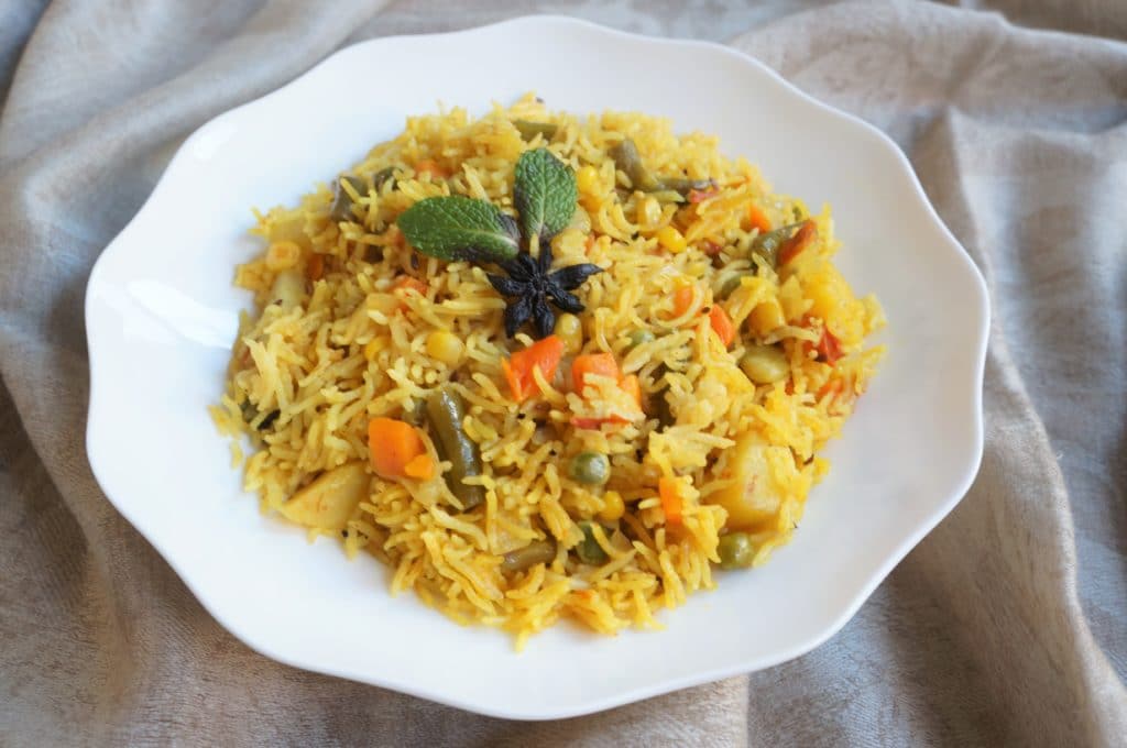Vegetable Pulao in a white bowl made in Instant Pot Pressure Cooker