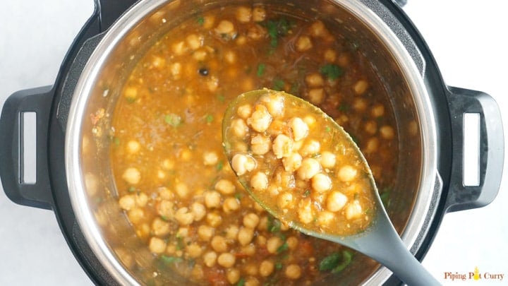 Pressure cooker Chole Masala cooked in a ladle over the instant pot