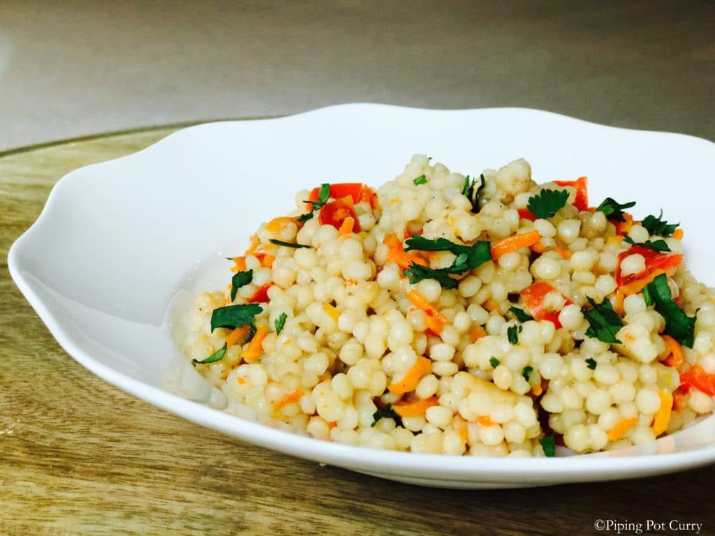 Couscous pulao in a white plate made in instant pot pressure cooker