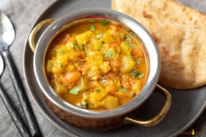 Bottle Gourd Curry (Lauki) in a bowl with roti and ghee