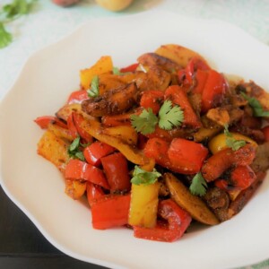 Aloo capsicum (also called bell pepper or Simla mirch) in a white bowl