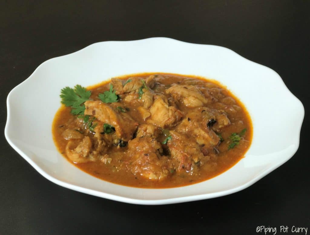 Chicken Curry in a white serving plate with cilantro