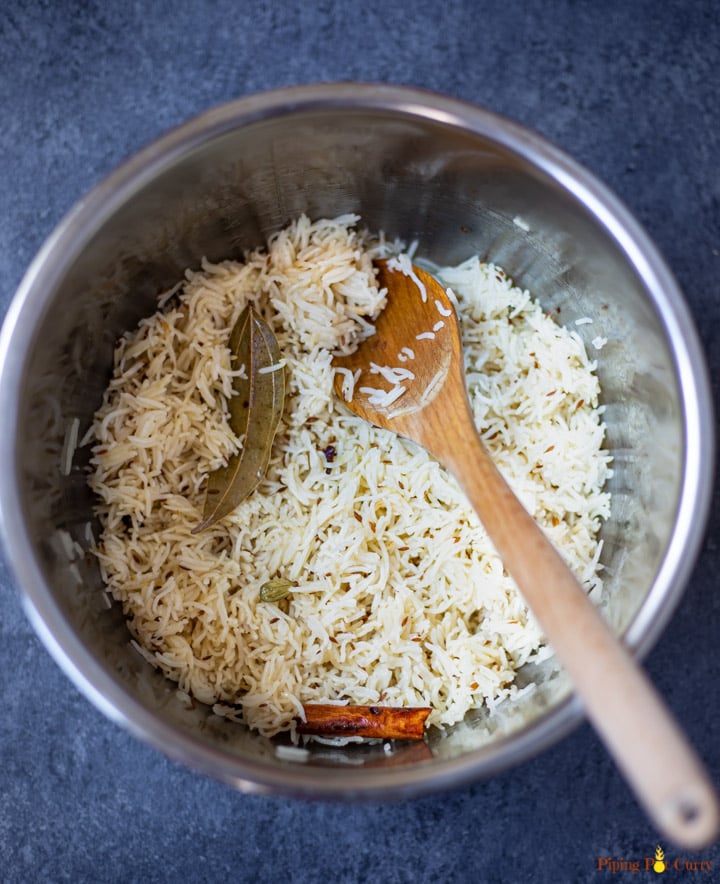 Cooked Basmati Rice flavored with cumin, cinnamon and bay leaf in instant pot pressure cooker