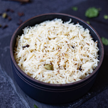 cumin rice in a black bowl