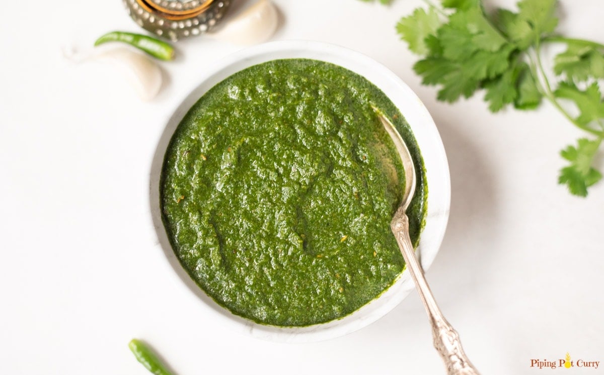 Indian green mint cilantro chutney in a white bowl