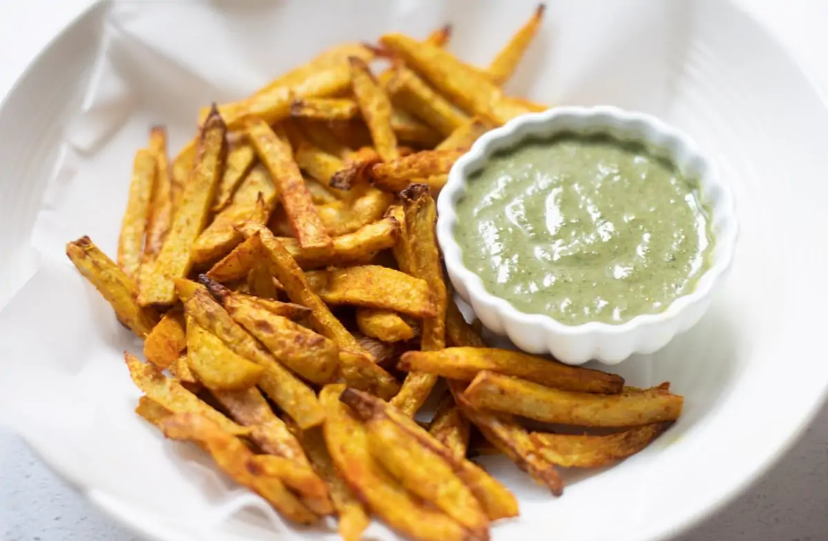 Taro Fries in a bowl with a green dip / chutney
