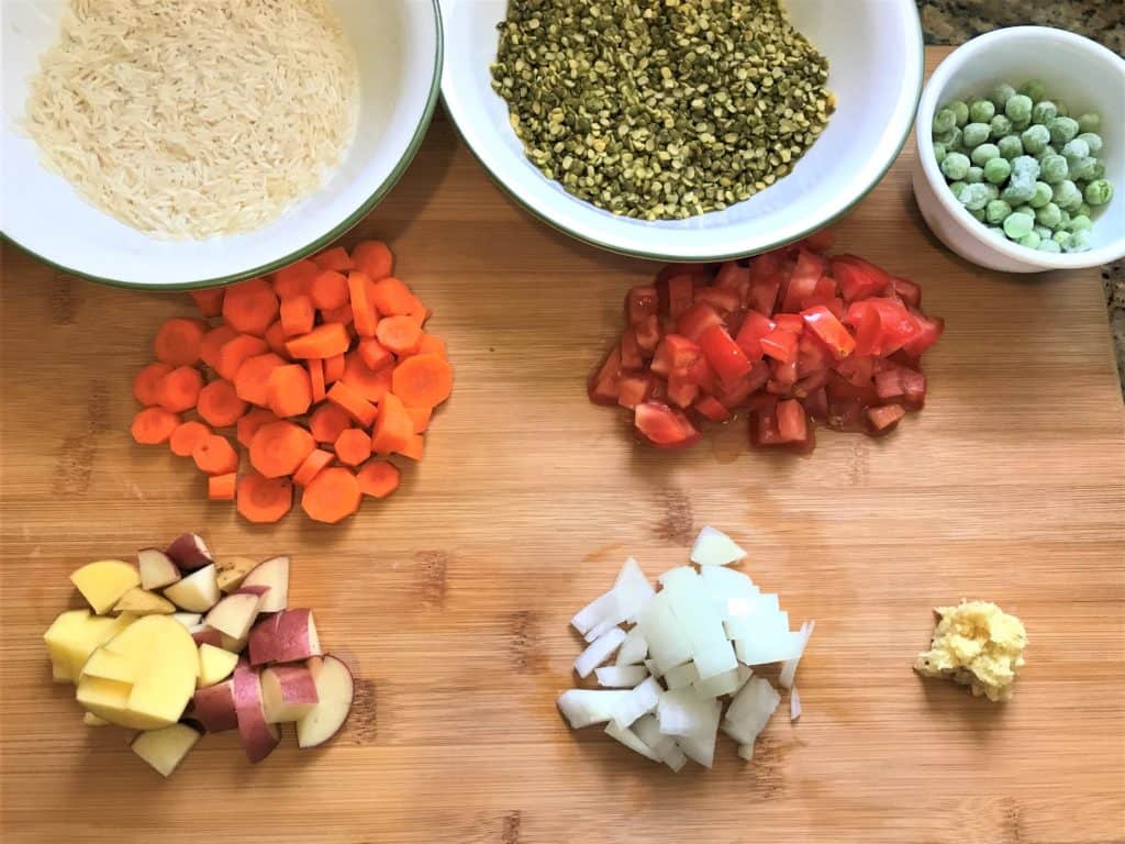 Pressure Cooker Masala Khichdi Ingredients - Rice, Split Green Lentils, Green Peas, Carrots, Potatoes, Onions, Tomatoes, Ginger