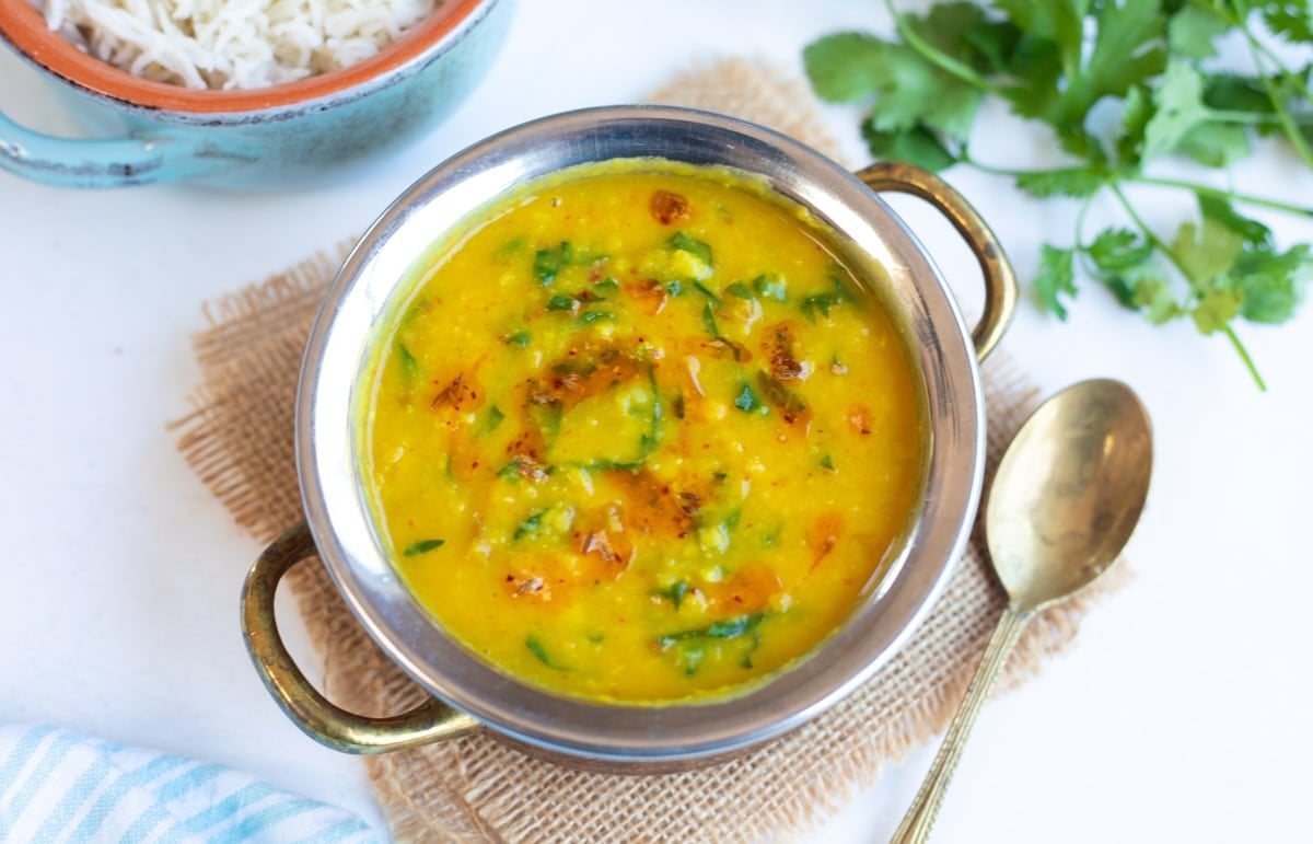 Dal Palak (Lentils with spinach) in a pretty bowl with rice on the side