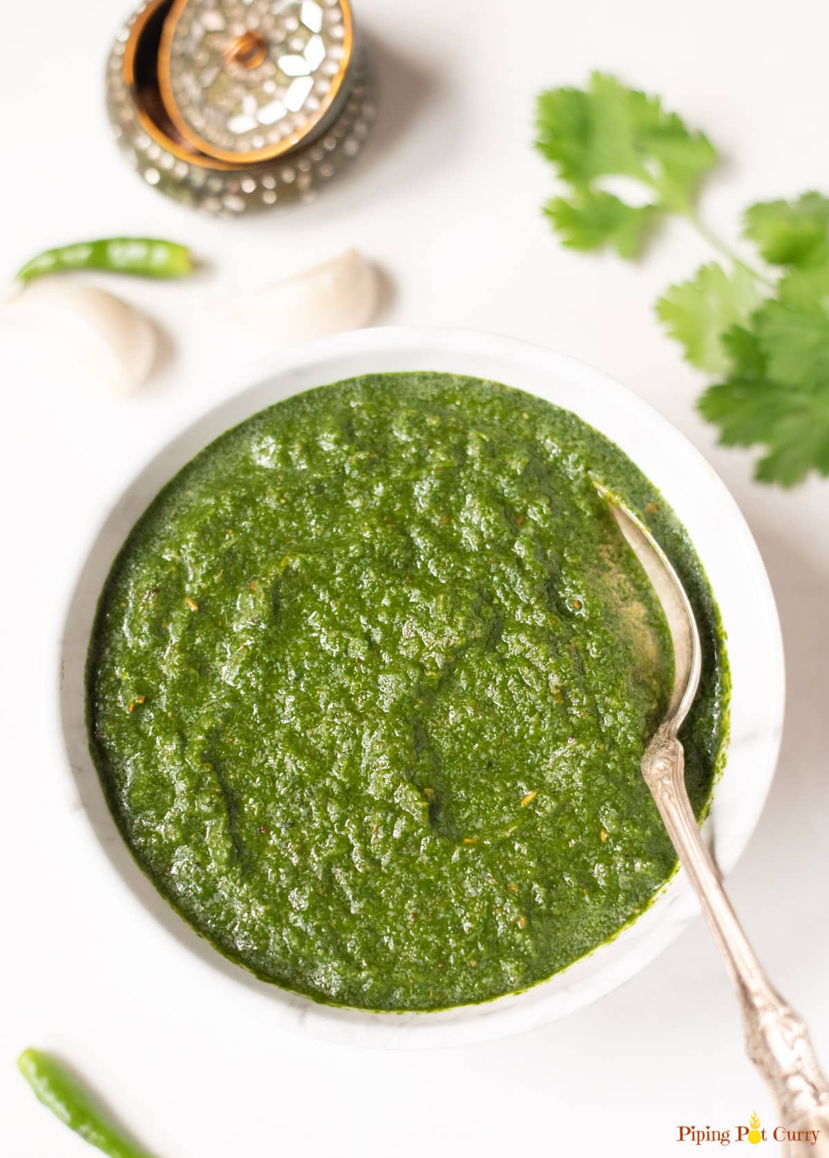 Indian green mint cilantro chutney in a white bowl