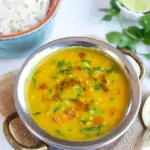 Dal Palak (Lentils with spinach) in a pretty bowl with rice on the side