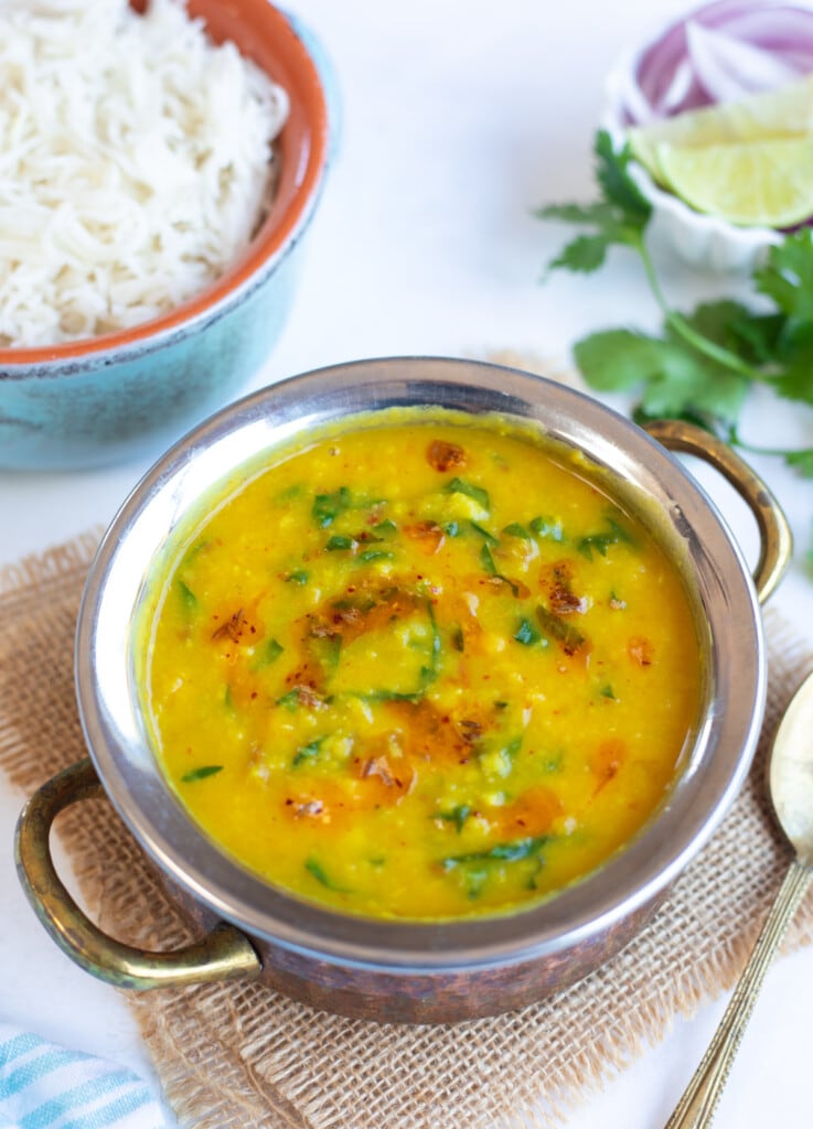 Dal Palak (Lentils with spinach) in a pretty bowl with rice on the side