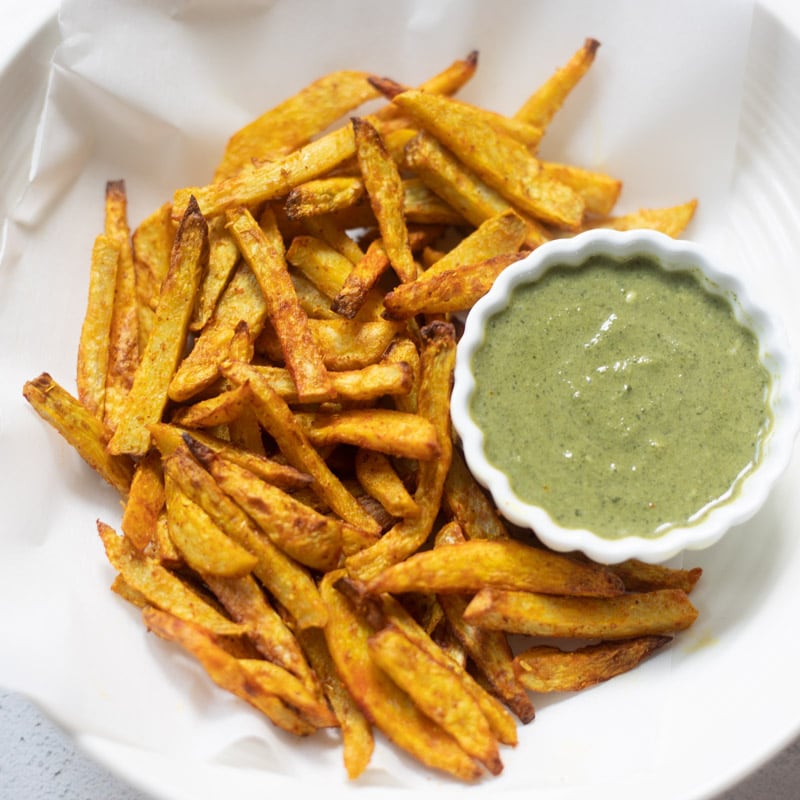 Taro fries in a bowl with a cilantro dip