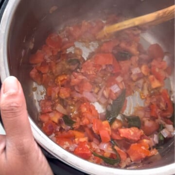 Saute tomatoes and spices to make chettinad chicken