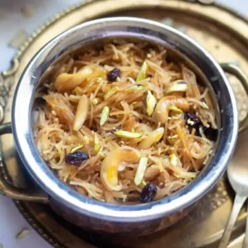 sweet vermicelli garnished with nuts and raisins in a pretty bowl