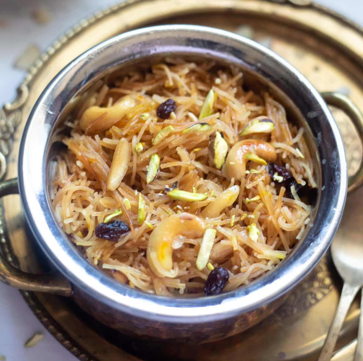 sweet vermicelli garnished with nuts and raisins in a pretty bowl