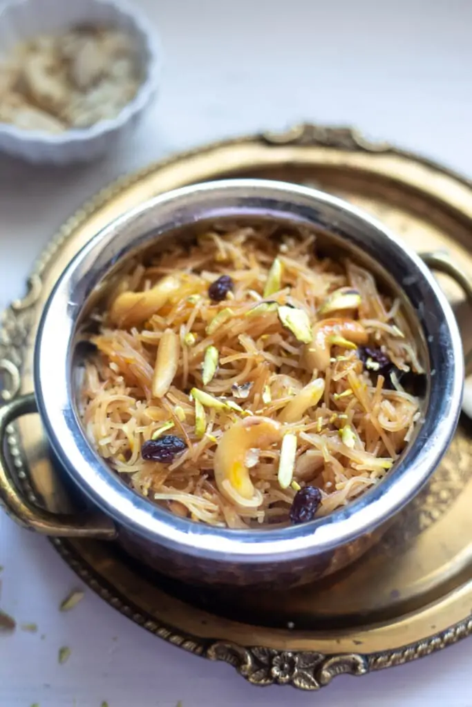 Meethi Seviyan served in a pretty bowl topped with nuts and raisins