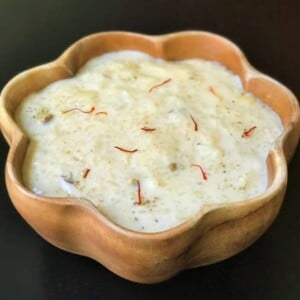 Kheer made in instant pot served in a wooden bowl.