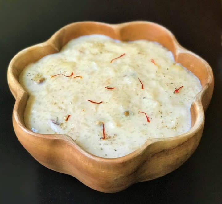 Kheer made in instant pot served in a wooden bowl. 
