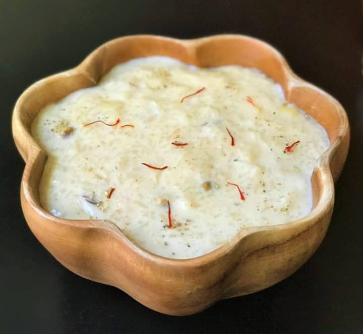 Kheer made in instant pot served in a wooden bowl.