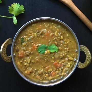 Green lentils in a bowl garnished with cilantro