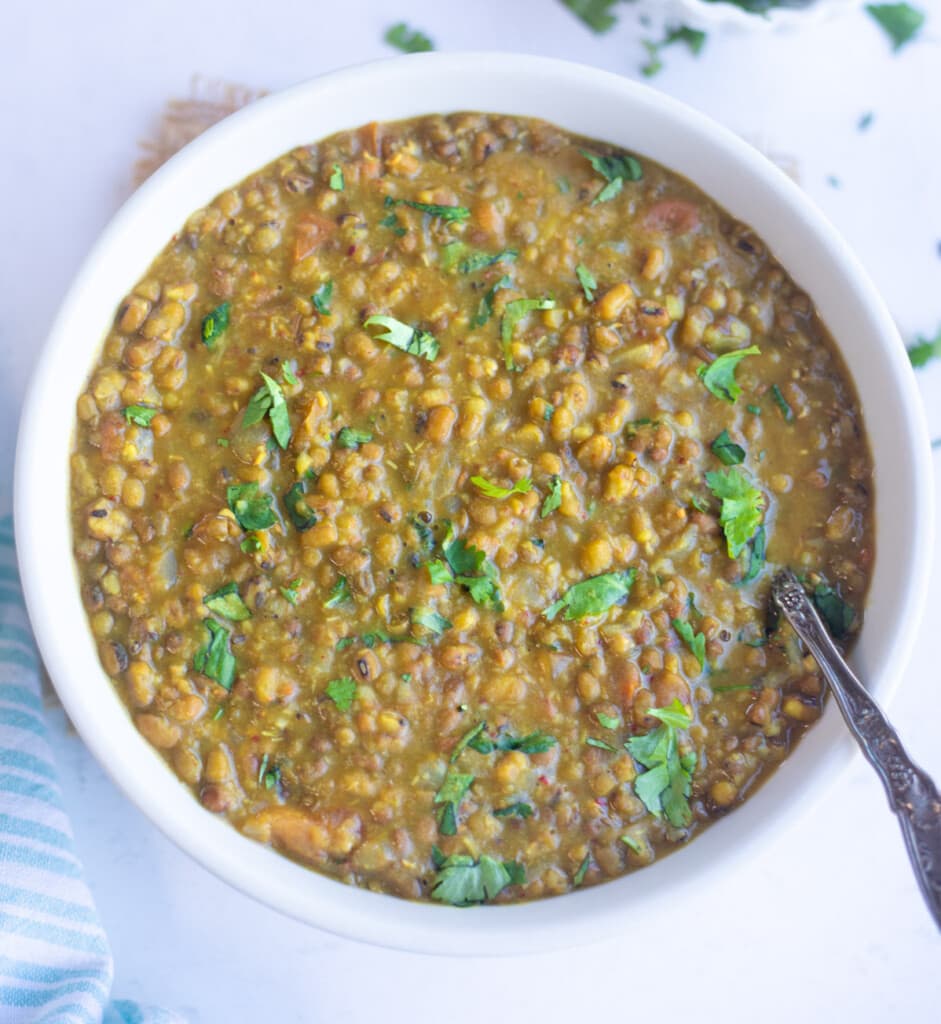 Green Moong Dal in a bowl topped with cilantro 