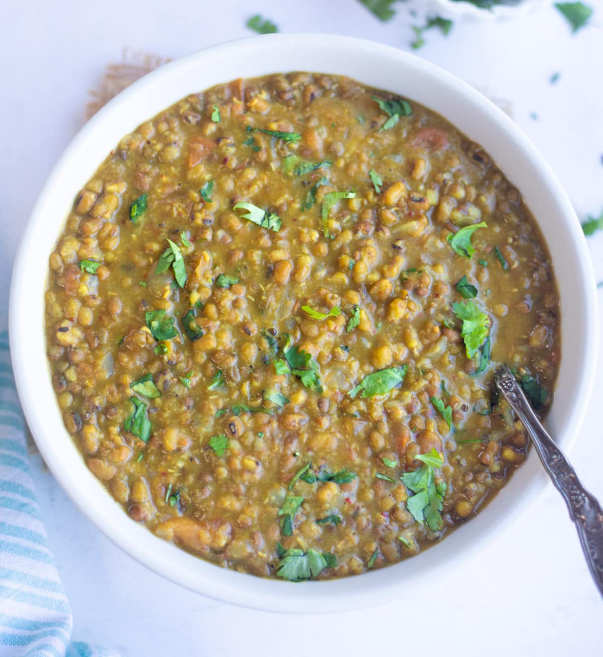 Green Moong Dal in a bowl topped with cilantro