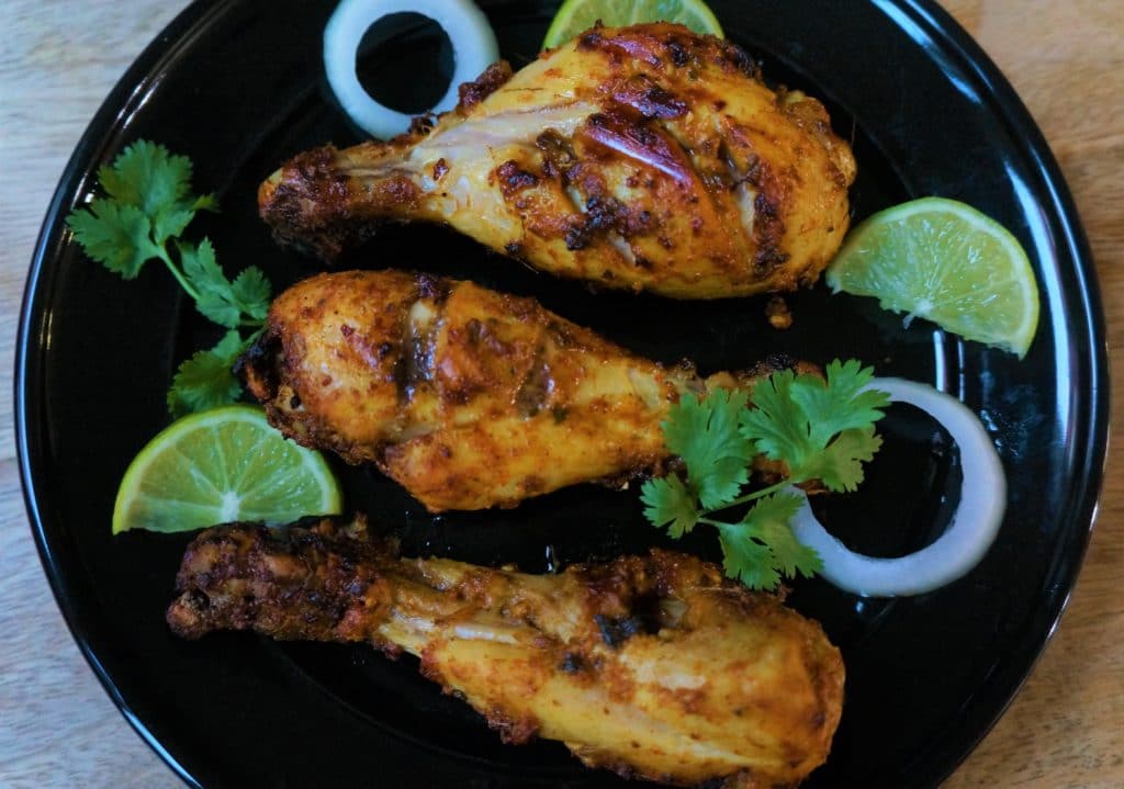 Tandoori Chicken made in the Air Fryer, a flavor packed spicy dish from the Indian subcontinent popular all venver the world. Chicken is marinated in yogurt, ginger, garlic, spices and lemon juice, then grilled in the air fryer or oven.