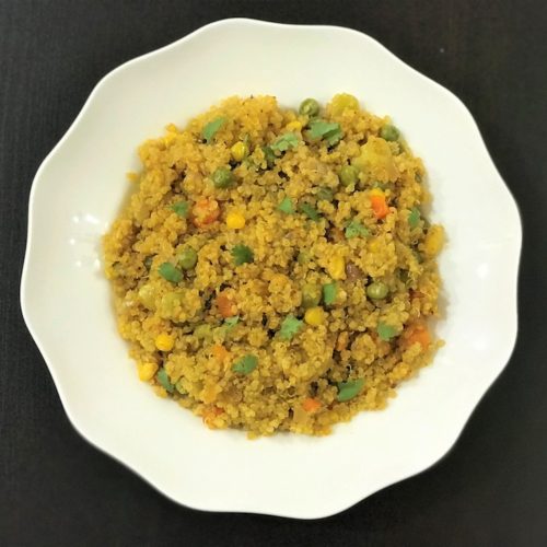 Quinoa with vegetables in a white bowl