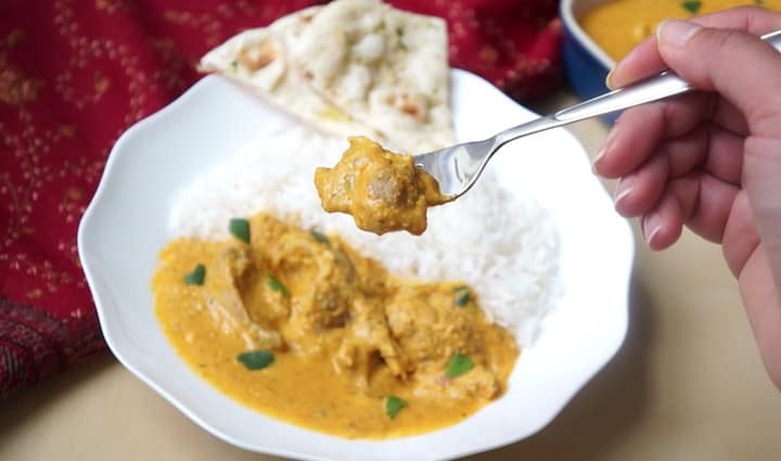 Butter Chicken Instant Pot Pressure Cooker - Close up with butter chicken in a fork