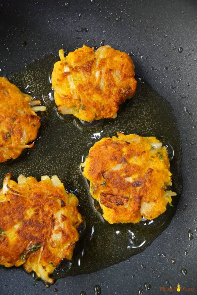 Four Vegan Chickpea Squash Fritters - Frying in a pan