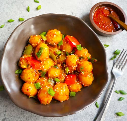 Garlic Chili potatoes in a bowl and chili sauce on the side