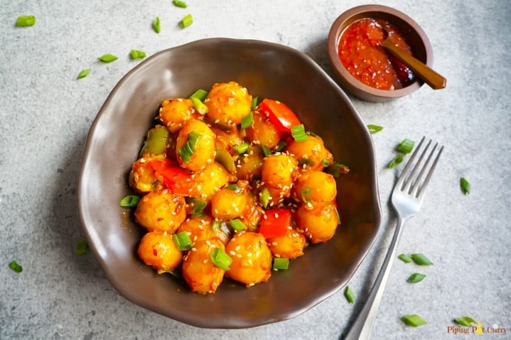 Garlic Chili potatoes in a bowl and chili sauce on the side