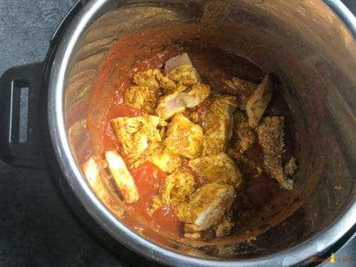 Instant Pot Chicken Tikka Masala - Step 2 - Add tomato paste, spices and cut chicken pieces