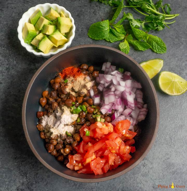 Kala Chana Chaat. Black Chickpea Salad - Start mixing the ingredients by adding to black chickpeas