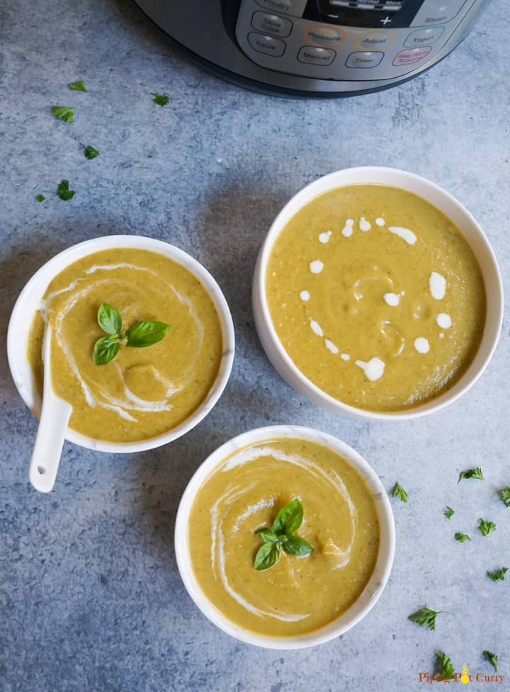 Pressure Cooker Cream of Broccoli Soup served in 3 bowls with basil to garnish