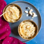 Sooji Halwa - Semolina Pudding served in 2 bowls topped with nuts and saffron