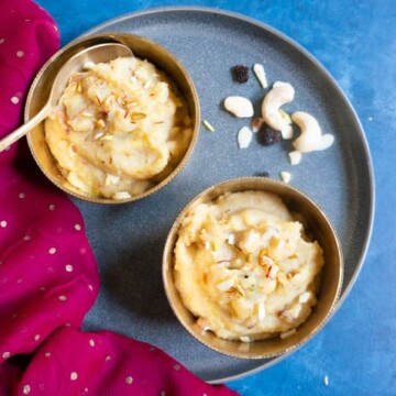 Sooji Halwa - Semolina Pudding served in 2 bowls topped with nuts and saffron