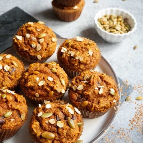 Healthy Whole Wheat Pumpkin Muffins in a white plate with sesame seeds on top