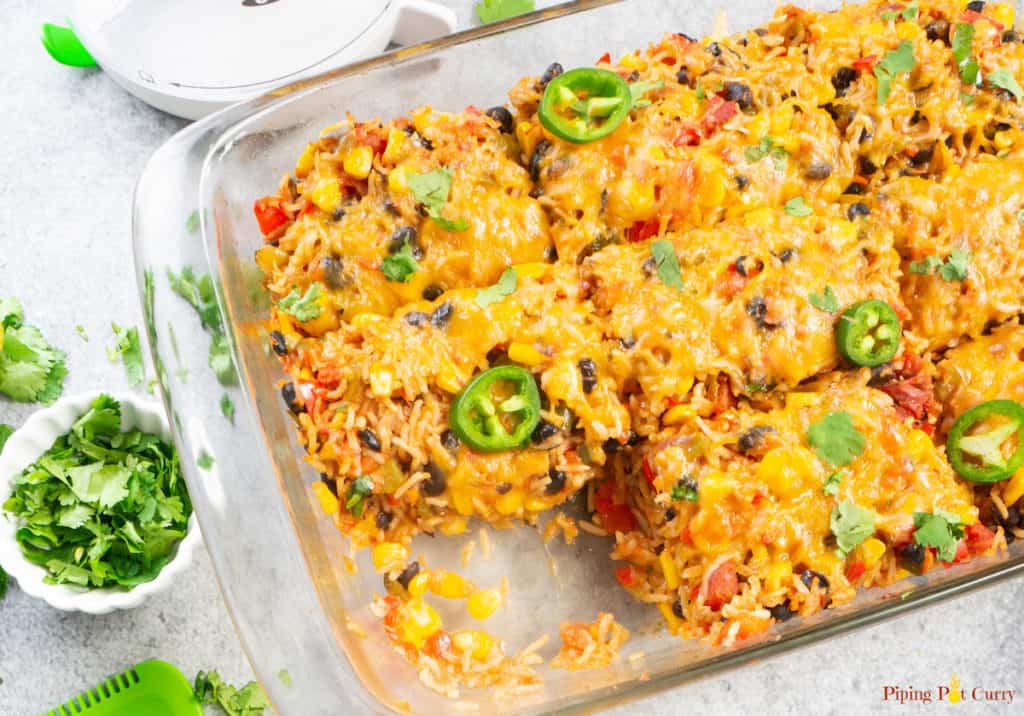 Healthy Vegetarian Mexican Rice & Bean Casserole is easy to make and filled with cheesy goodness, along with brown rice and lots of veggies. This is an easy gluten free & vegetarian casserole for a weeknight dinner or your next party!