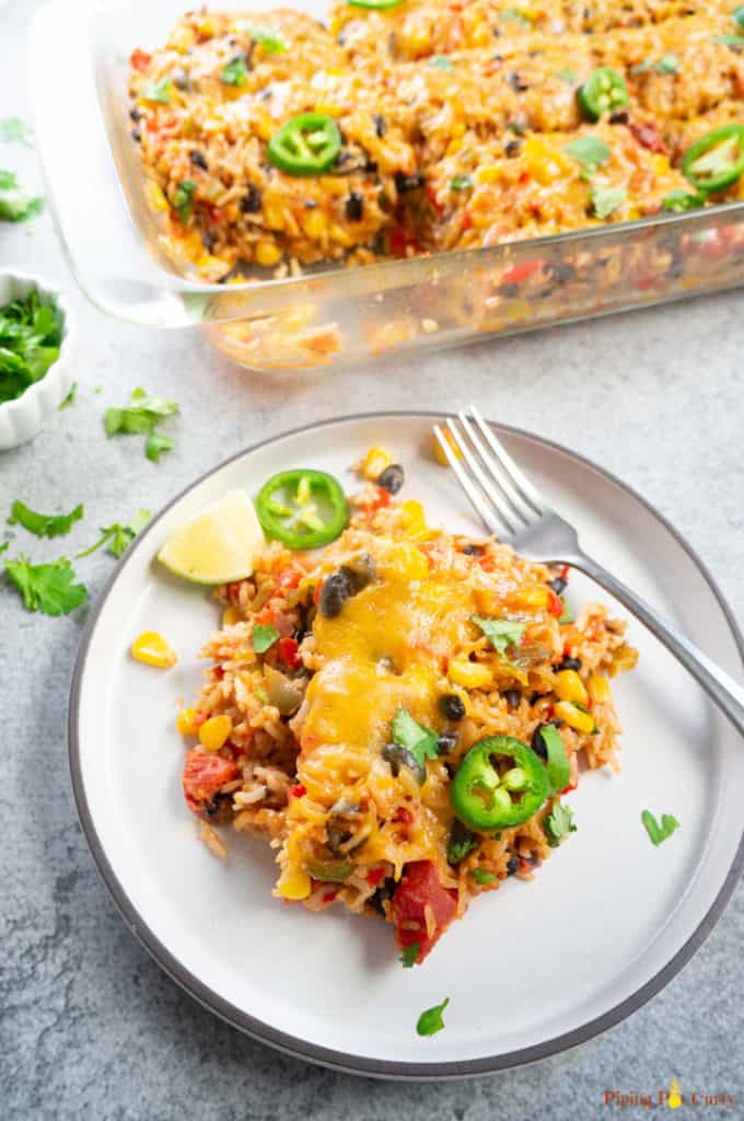 Vegetarian Mexican Casserole with Rice & Beans served on a white plate along with a fork.