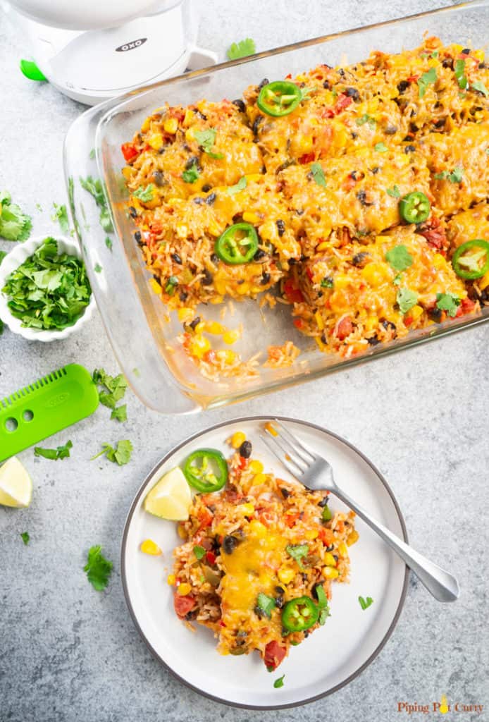 Vegetarian Mexican Casserole with Rice & Beans served on a white plate along with a fork. 