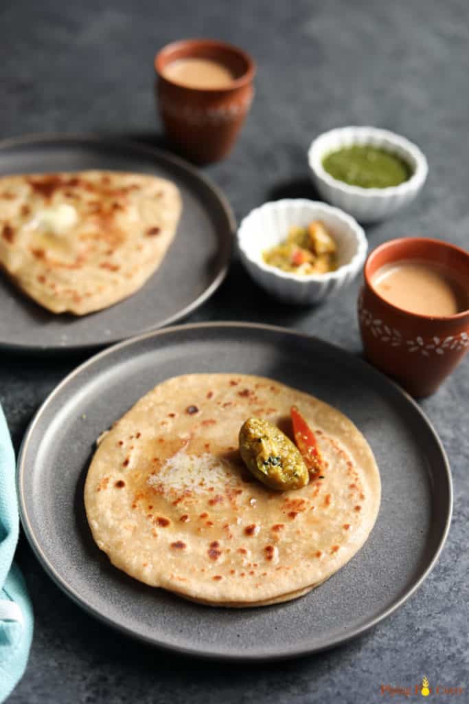 Paratha, pan fried indian flatbread along with pickle and chai