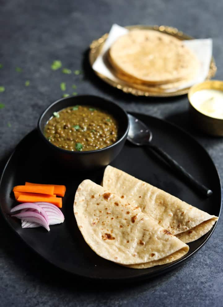 Phulka Roti - Chapati - Whole Wheat Indian Flatbread in a plate with dal