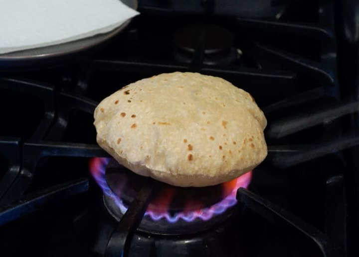 Image of Making Roti (Indian Chapati) On Roti Tawa Made Of Wheat