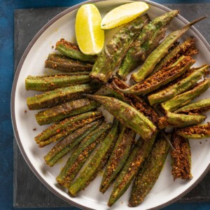 punjabi style Bharwa Bhindi with spices in a plate with lemon wedges