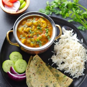 Ridge Gourd Curry or Turai ki subii served with roti, rice and salad in a plate